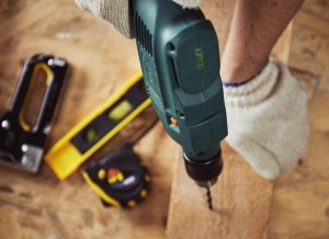Carpenter using woodworking tools for a project.