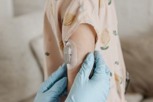 Continuous Glucose Monitor on girl's arm